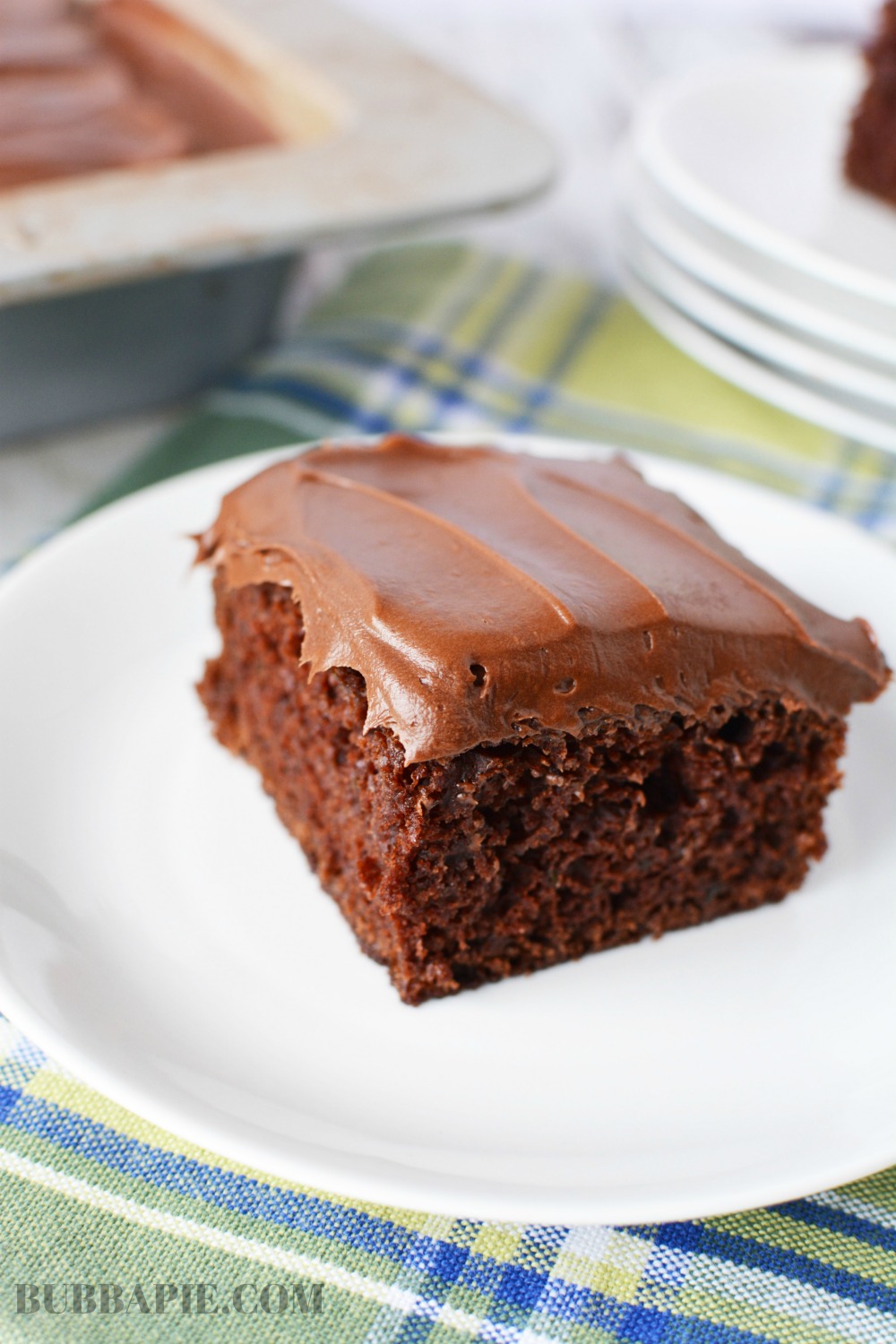 A slice of Chocolate Zucchini Cake on a white plate