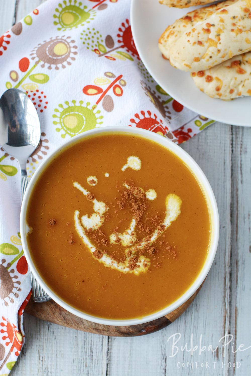 Butternut Squash Soup being served on a table with Fall decorations. 