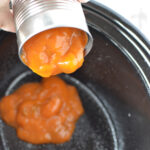 Pouring Soup and Water into Slow Cooker to make cube steak