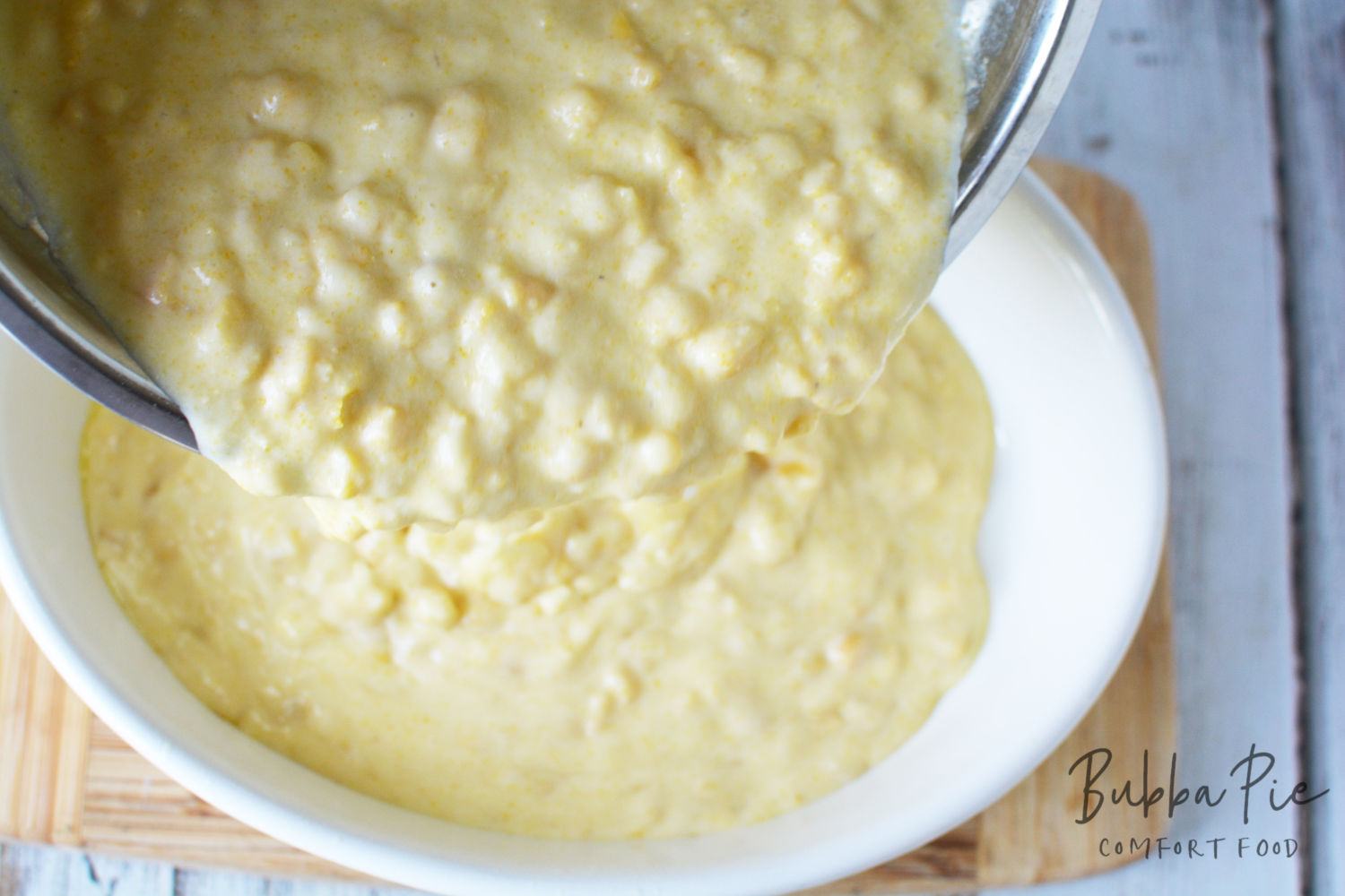 corn pudding recipe being poured in casserole dish