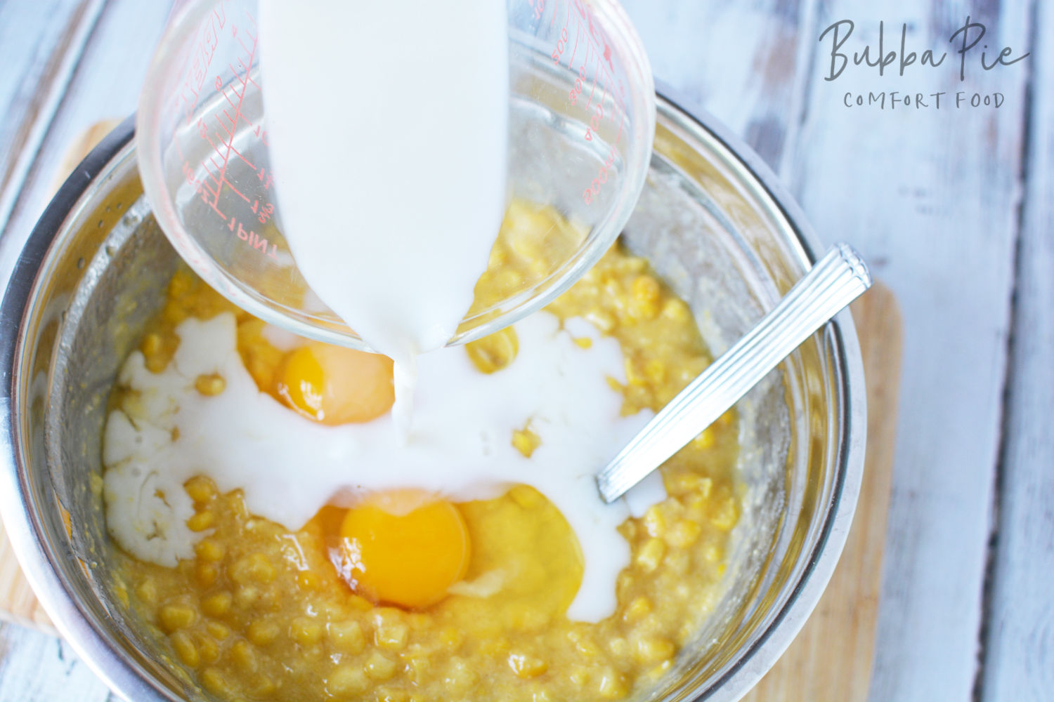 jiffy corn pudding ingredients being mixed in a bowl