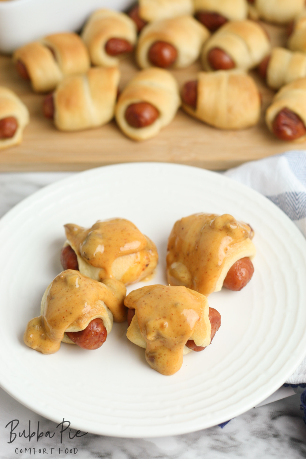 this mini pigs in a blanket with chili cheese sauce recipe is so easy to make with your slow cooker or crock pot!
