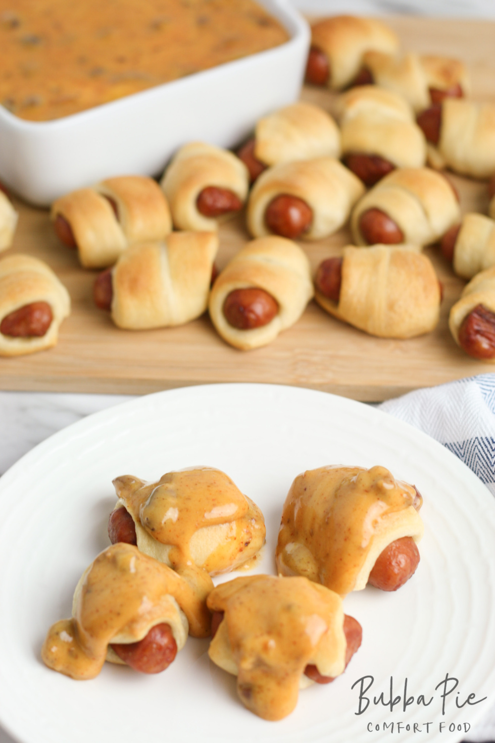 these mini pigs in a blanket with chili cheese sauce are the perfect appetizer or snack for a crowd.
