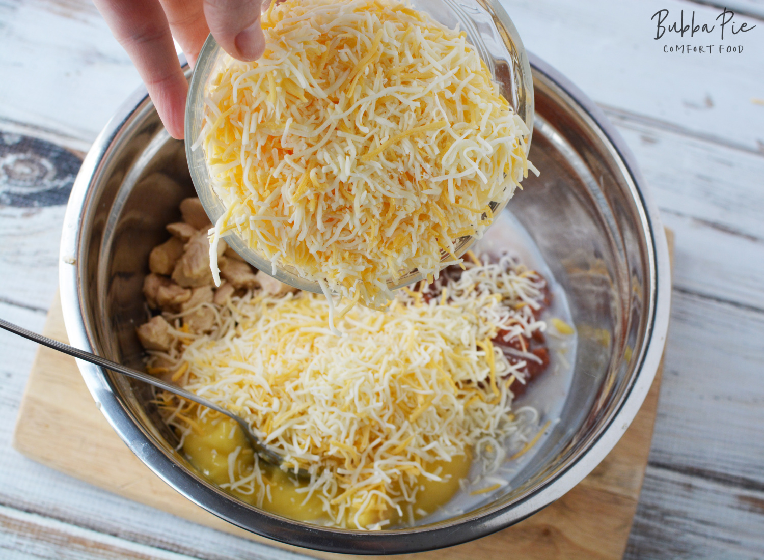 Chicken Dorito Casserole Recipe getting all the ingredients mixed together. I used Colby Jack Cheese but you can substitute Mexican blended cheese. 