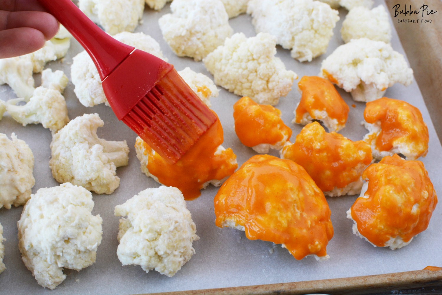 Cauliflower Wings are coated with Buffalo Sauce Before going into the oven.