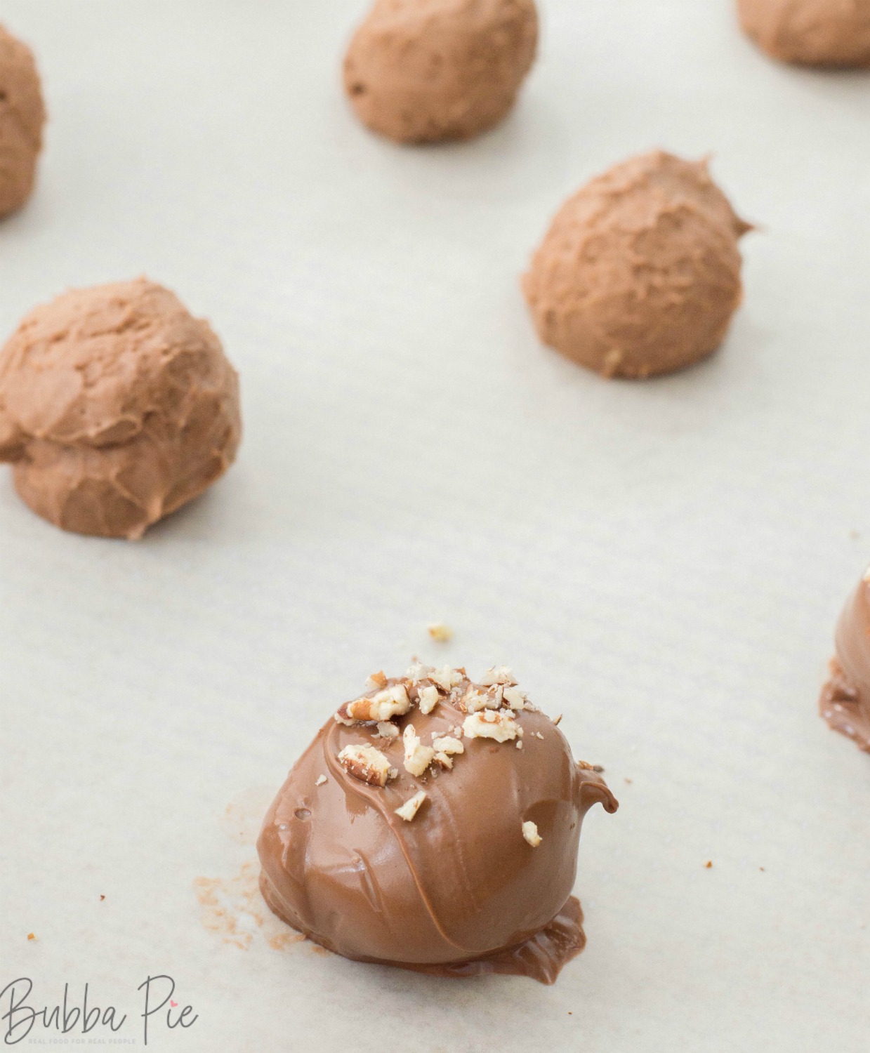 Whiskey Balls can be made with bourbon too. Put Chopped or crushed pecans on top of them after you dip them in chocolate. 