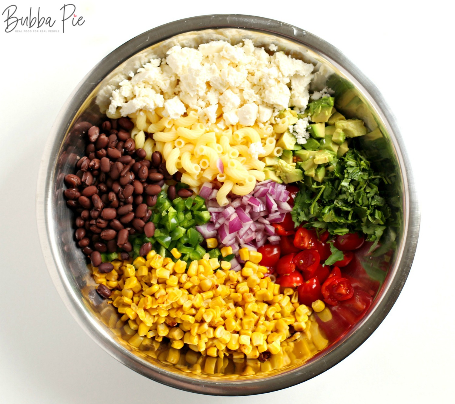Mexican Street Corn Pasta Salad includes corn, black beans, avocado, macaroni and tomatoes