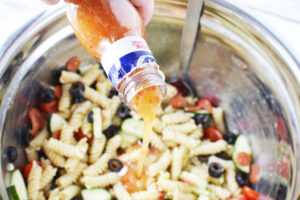 Add dressing to rotini pasta salad