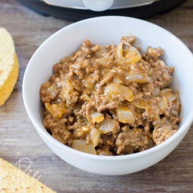 Instant Pot Taco Meat sitting next to a pressure cooker and taco shells