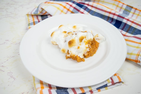 instant pot sweet potato casserole sitting on a table decorated for Thanksgiving