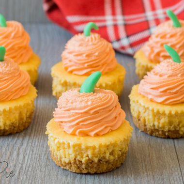 mini pumpkin cheesecake with graham cracker crust sitting on a table