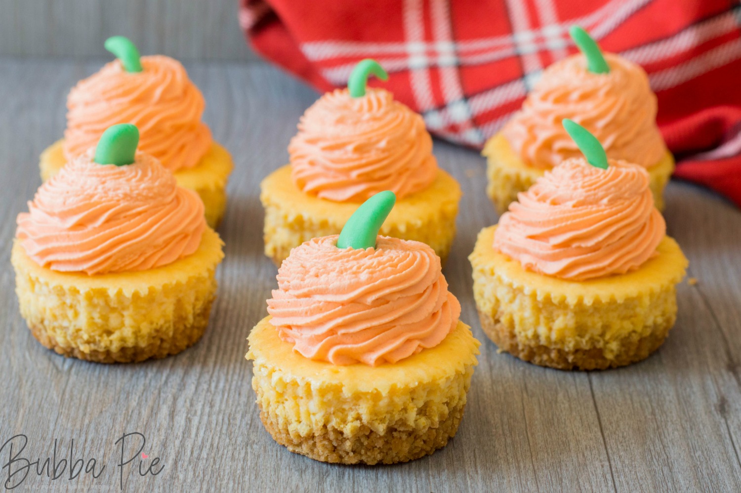 mini pumpkin cheesecake with graham cracker crust sitting on a table