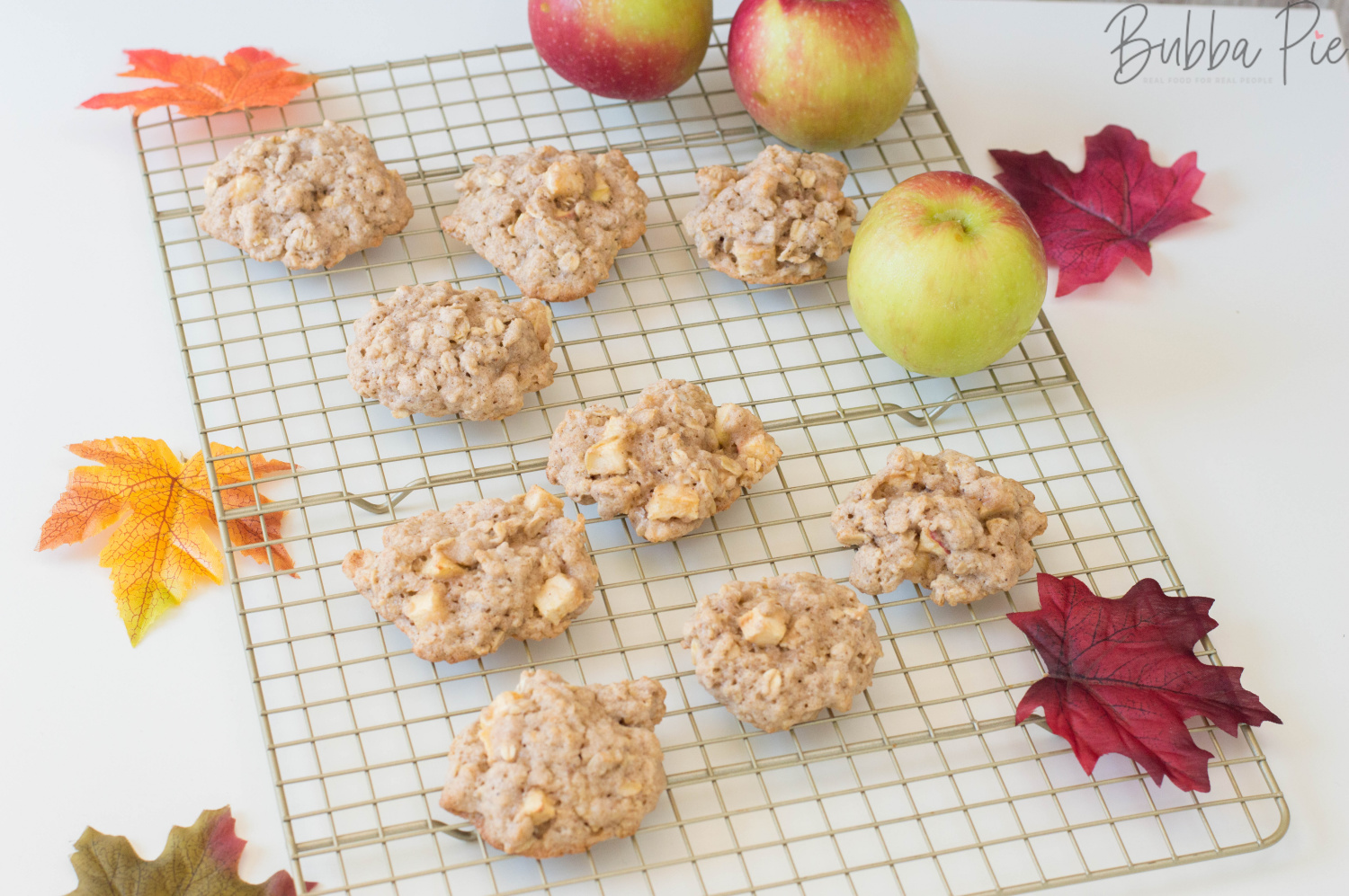 Apple Oatmeal Cookies Sitting on a cooling rack surrounded by Fall decorations