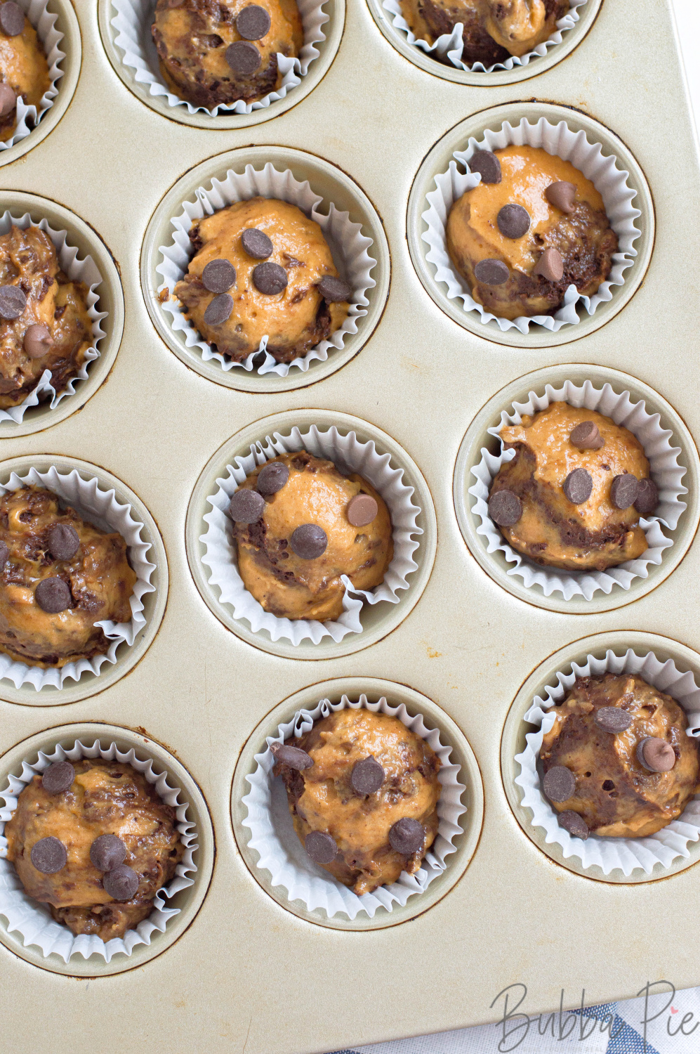 This best Pumpkin Chocolate Chip Muffins recipe is ready to bake in the muffin liners