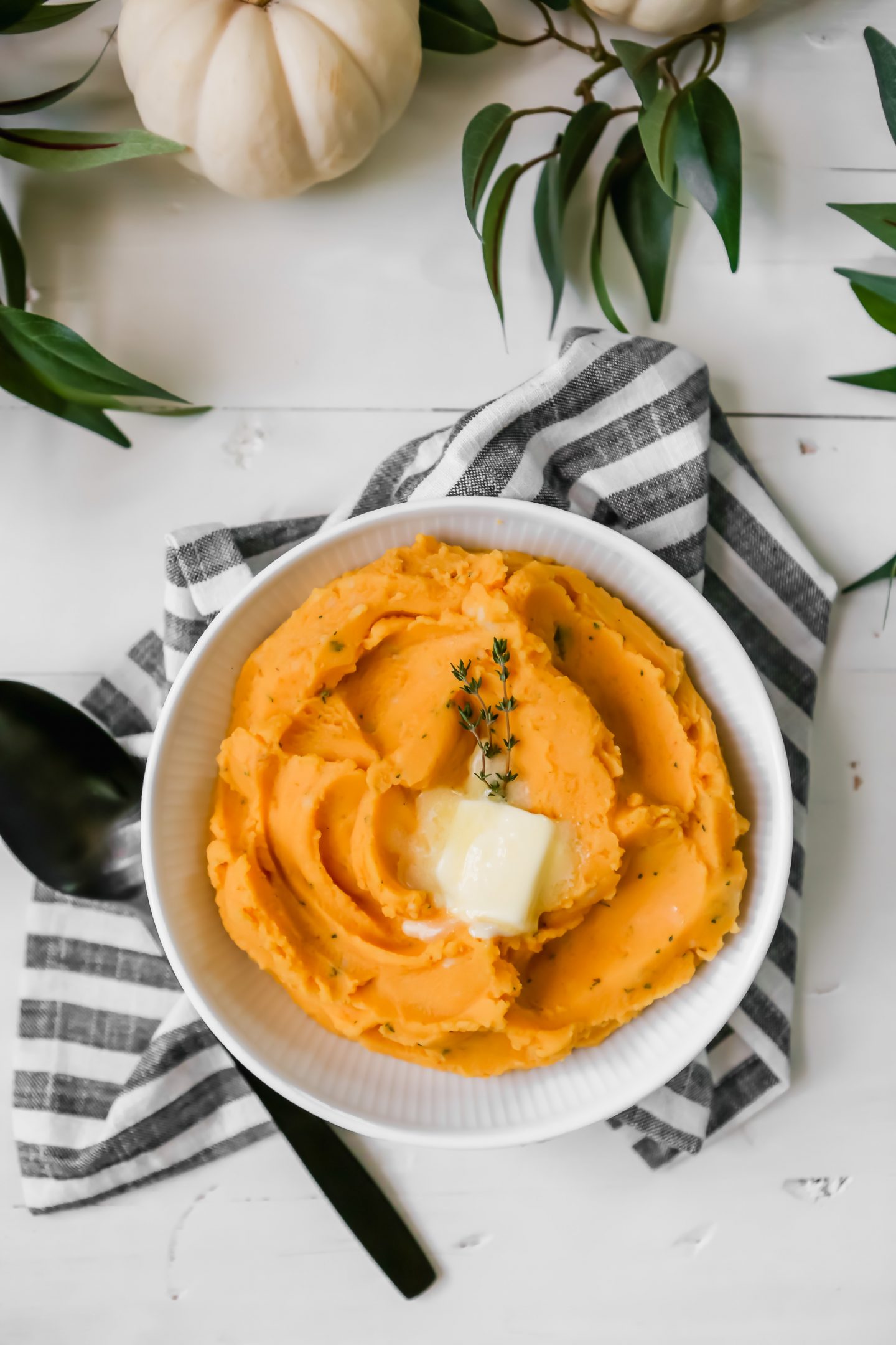 Buttermilk Pumpkin mashed potatoes sitting on a table decorated for thanksgiving