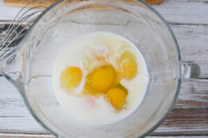 Mix eggs, milk, vanilla and salt.