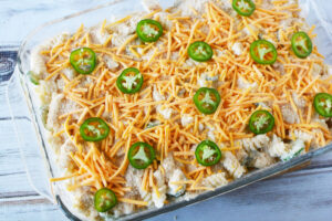 Top casserole with jalapenos and cheese.