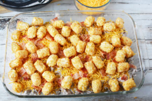 adding more tater tots on top