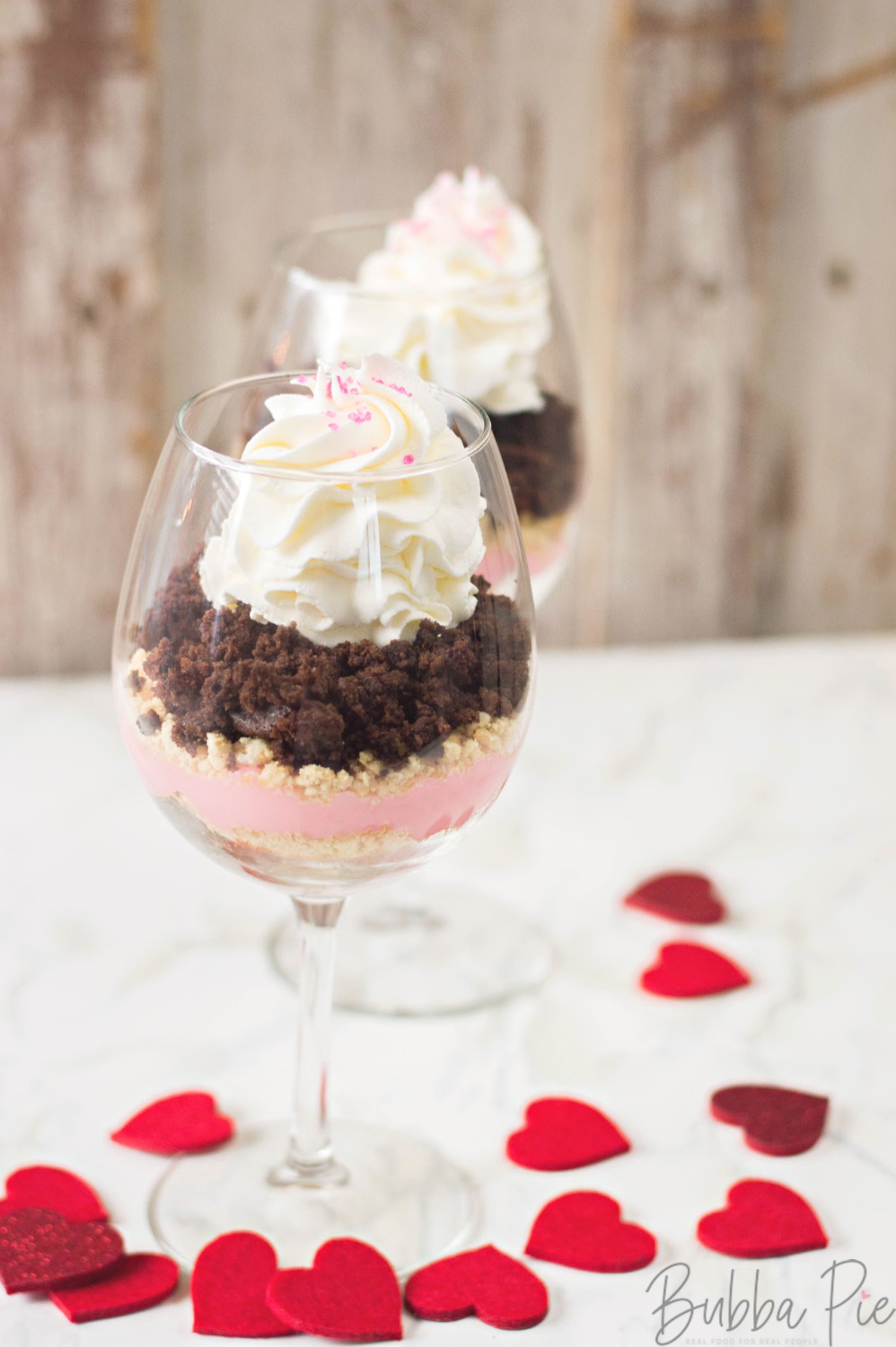 Pudding Parfait Recipe sitting on a table decorated for Valentine's Day