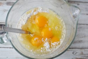 mix cake mix, eggs, oil and half the can of crushed pineapple
