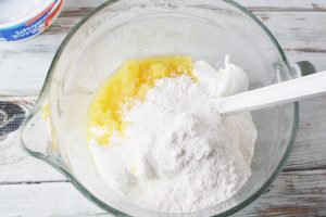 In a large mixing bowl, add remaining pineapple, whipped topping and vanilla pudding