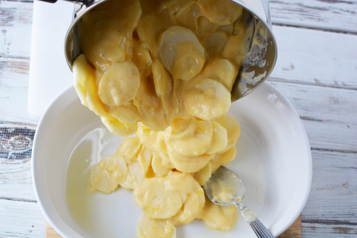 Pour Au Gratin Potatoes into prepared pan.