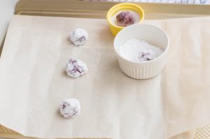 coat the red velvet dough ball in powdered sugar