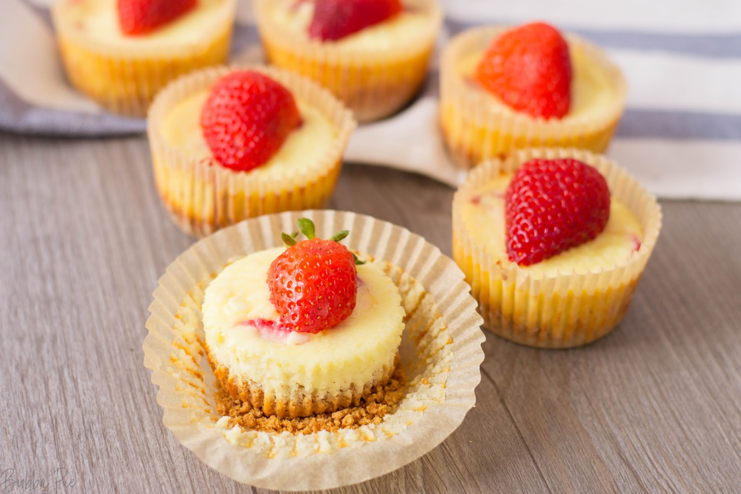 Easy Mini Strawberry Cheesecake Recipe has a layer of graham cracker crust and rich cheesecake.