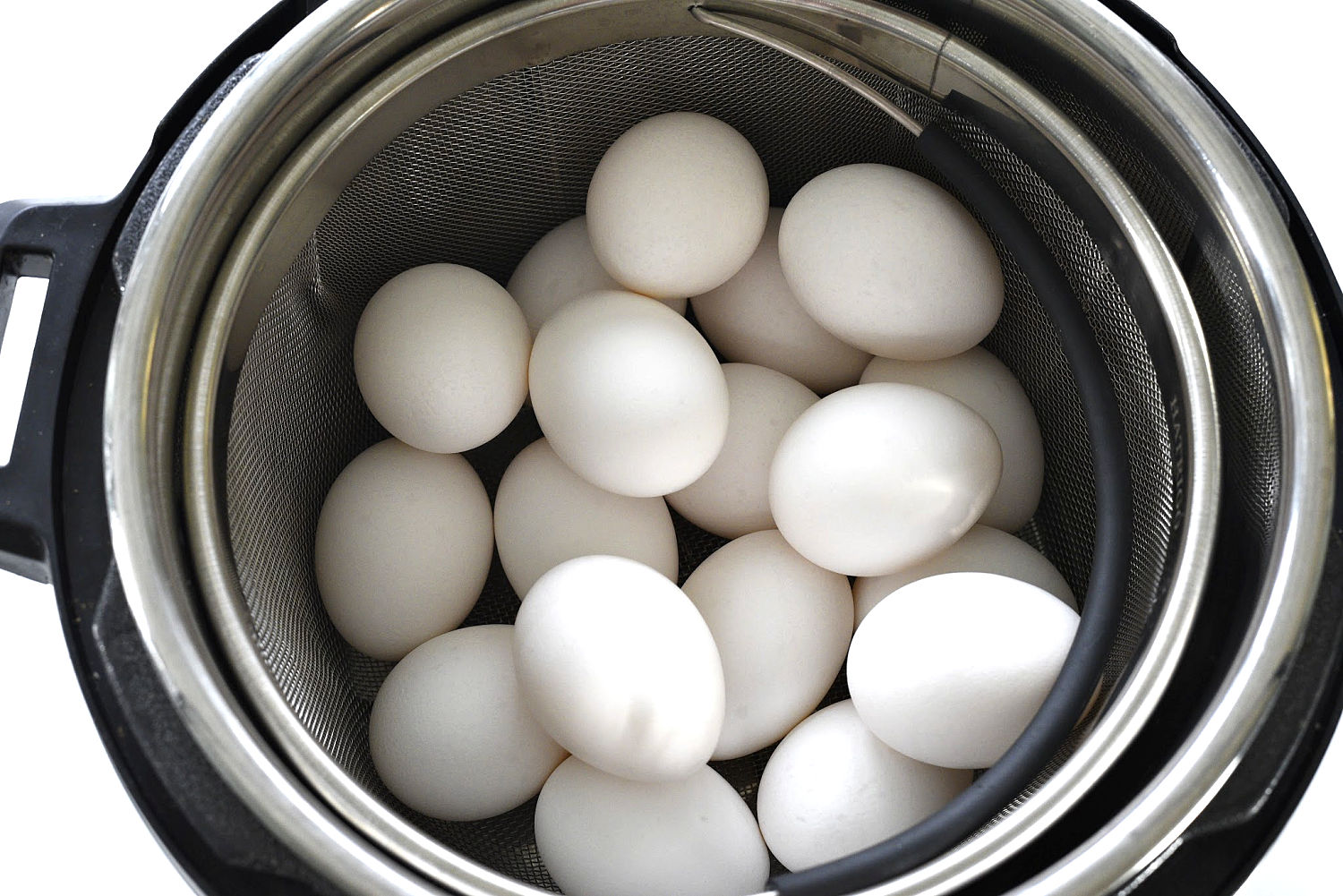 A pot full of eggs sitting in a pressure cooker