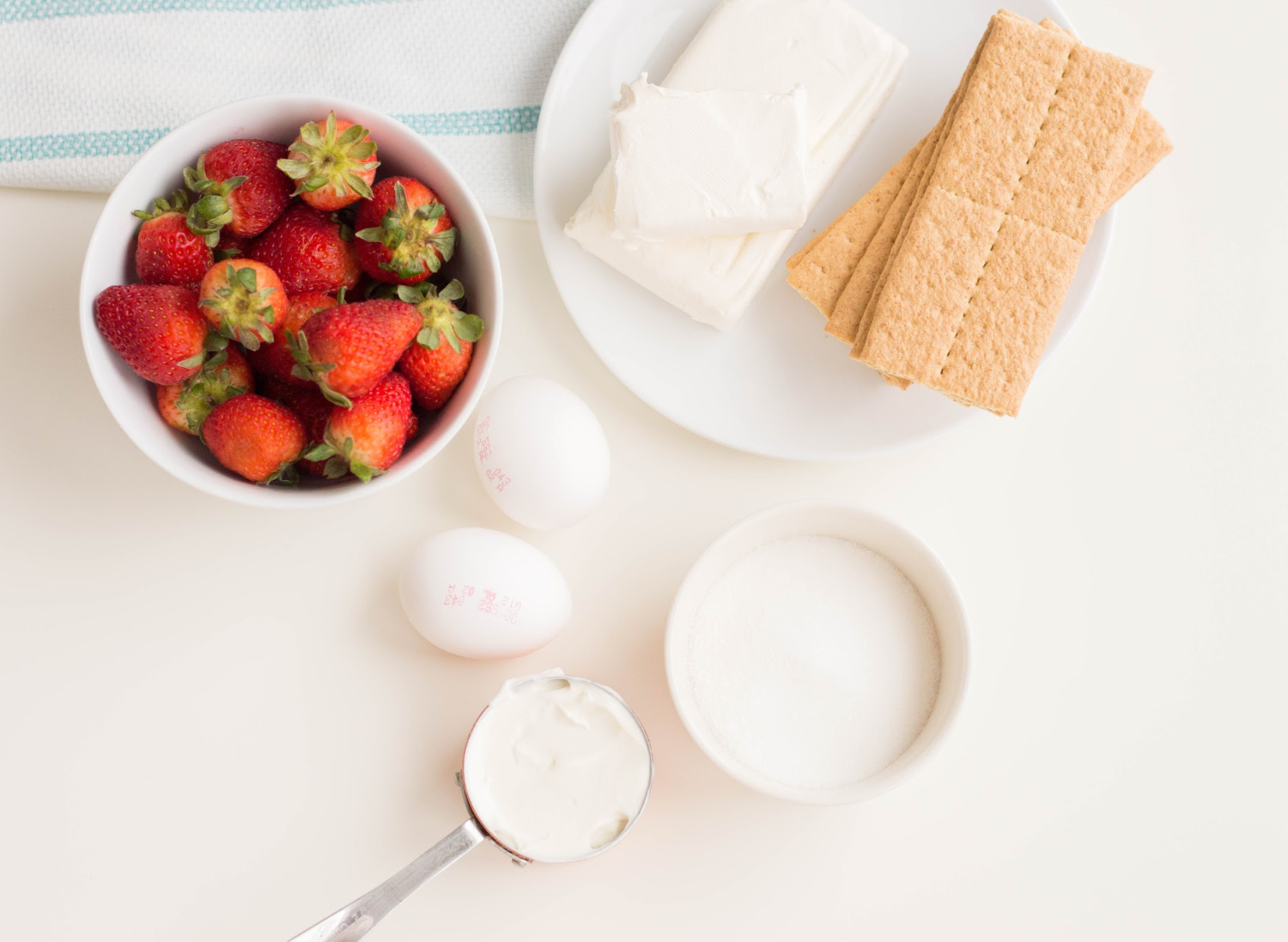 Mini Strawberry Cheesecake Ingredients include cream cheese, strawberries, sugar and graham crackers