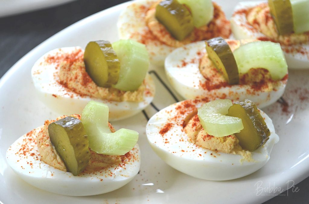 bloody mary eggs garnished with gherkins and celery