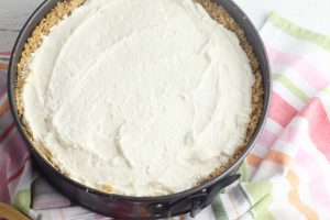 Spread the cream cheese mixture over the chilled crust until smooth.
