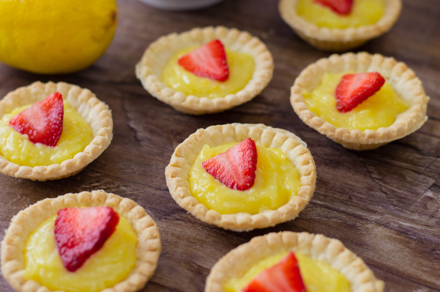 Mini Strawberry Lemon Tarts Recipe has fresh lemon filling with fresh strawberries on top.