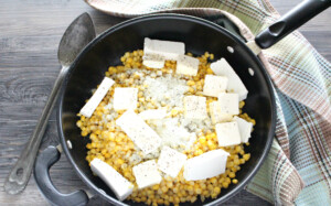 add butter and cream cheese to corn