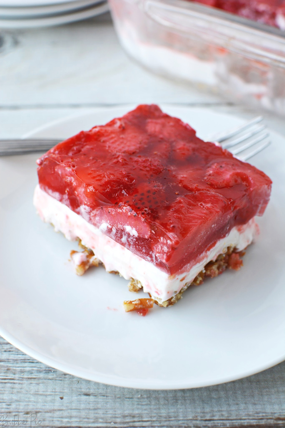 Strawberry Pretzel Salad sitting on a plate ready to be served for dessert.