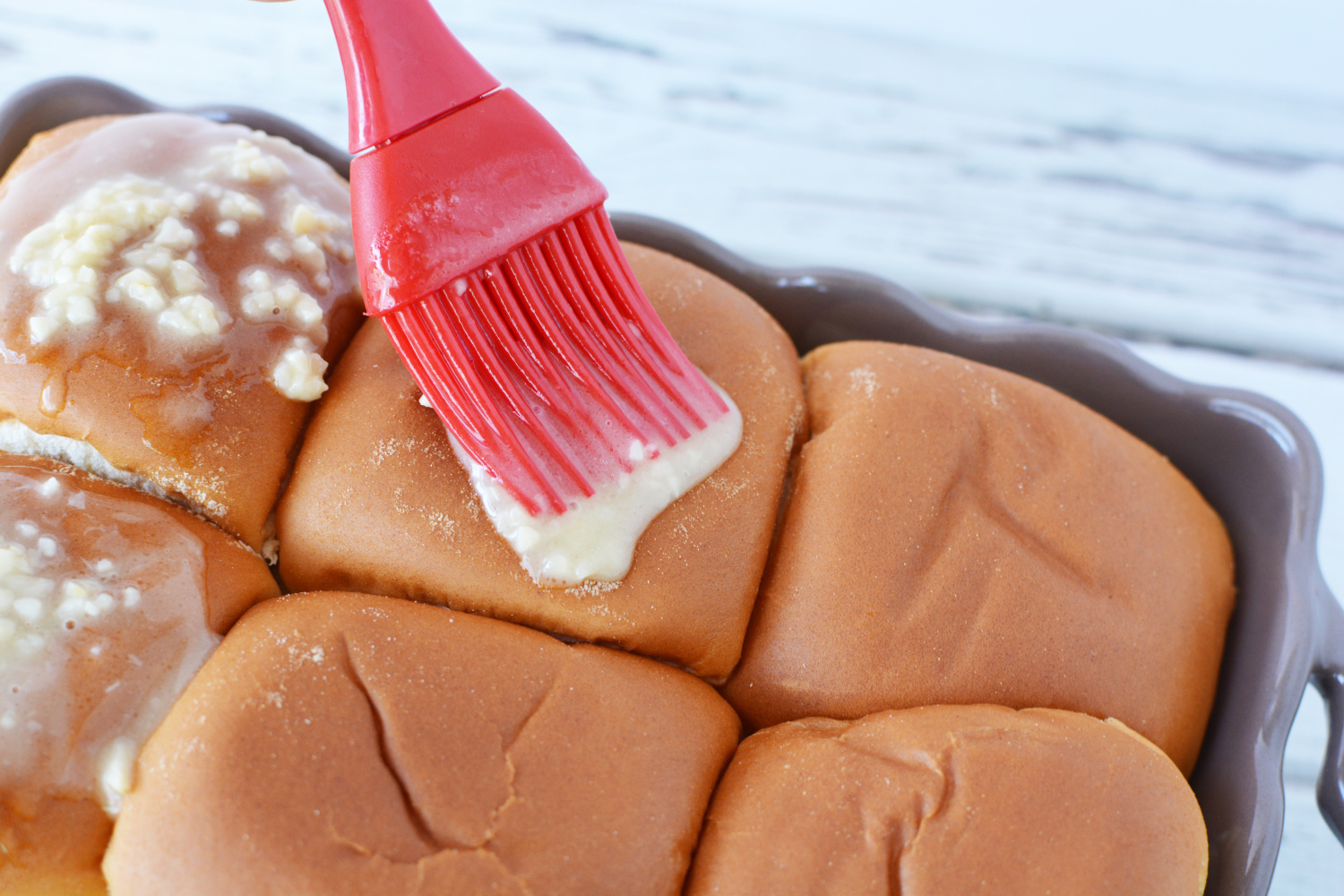 French Dip Sliders garnished with garlic butter.