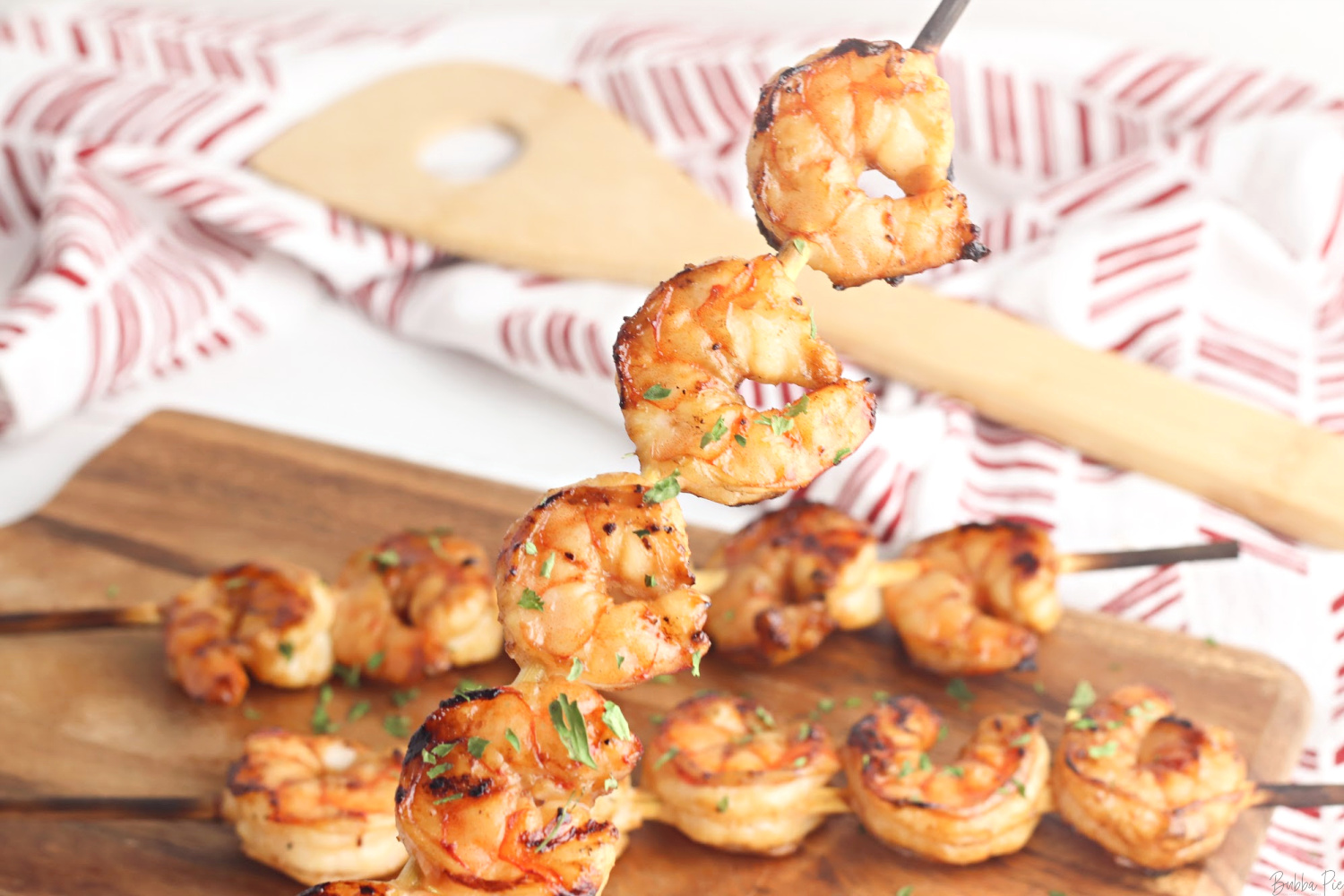 Grilled Teriyaki Shrimp Skewers being served on the cutting board. 