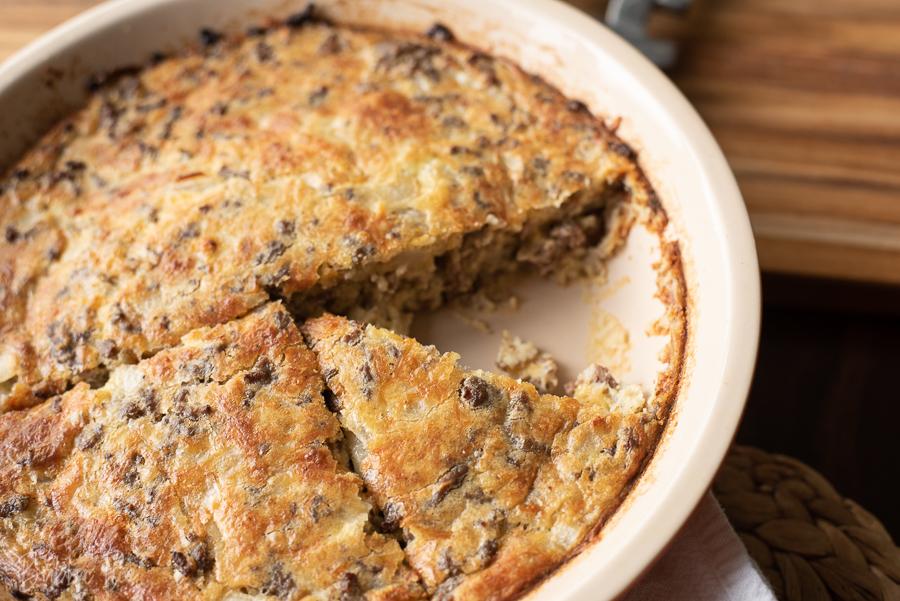Impossible Cheeseburger Pie is made with ground beef, cheese, onion and bisquick.