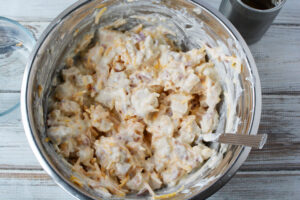 Mixing chicken, bacon and ranch dressing together