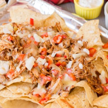 BBQ Chicken Nachos made with bell peppers, onions and cheese.