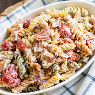 Bacon Ranch Pasta Salad has sour cream, mayonnaise, cheese and tomatoes.