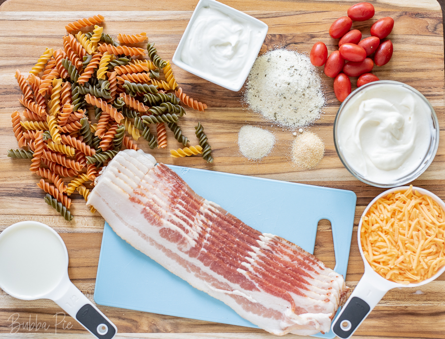 Bacon Ranch Pasta Salad Ingredients include cheese, sour cream, mayonnaise, garlic and onion salt.