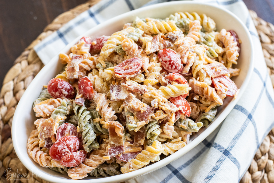 Bacon Ranch Pasta Salad has sour cream, mayonnaise, cheese and tomatoes. 