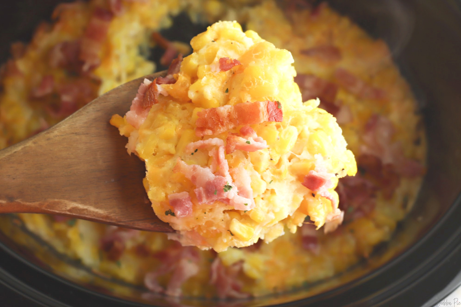 Corn Casserole Crockpot Recipe being served as a side dish.