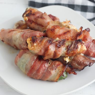 Grilled Jalapeno Poppers are wrapped in bacon and grilled to crispy perfection. Cheesy and spicy, they make an awesome appetizer.