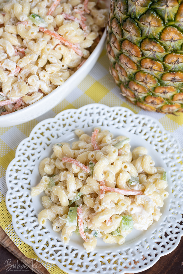 Hawaiian Pasta Salad Recipe being served on a table with a fresh pineapple. 