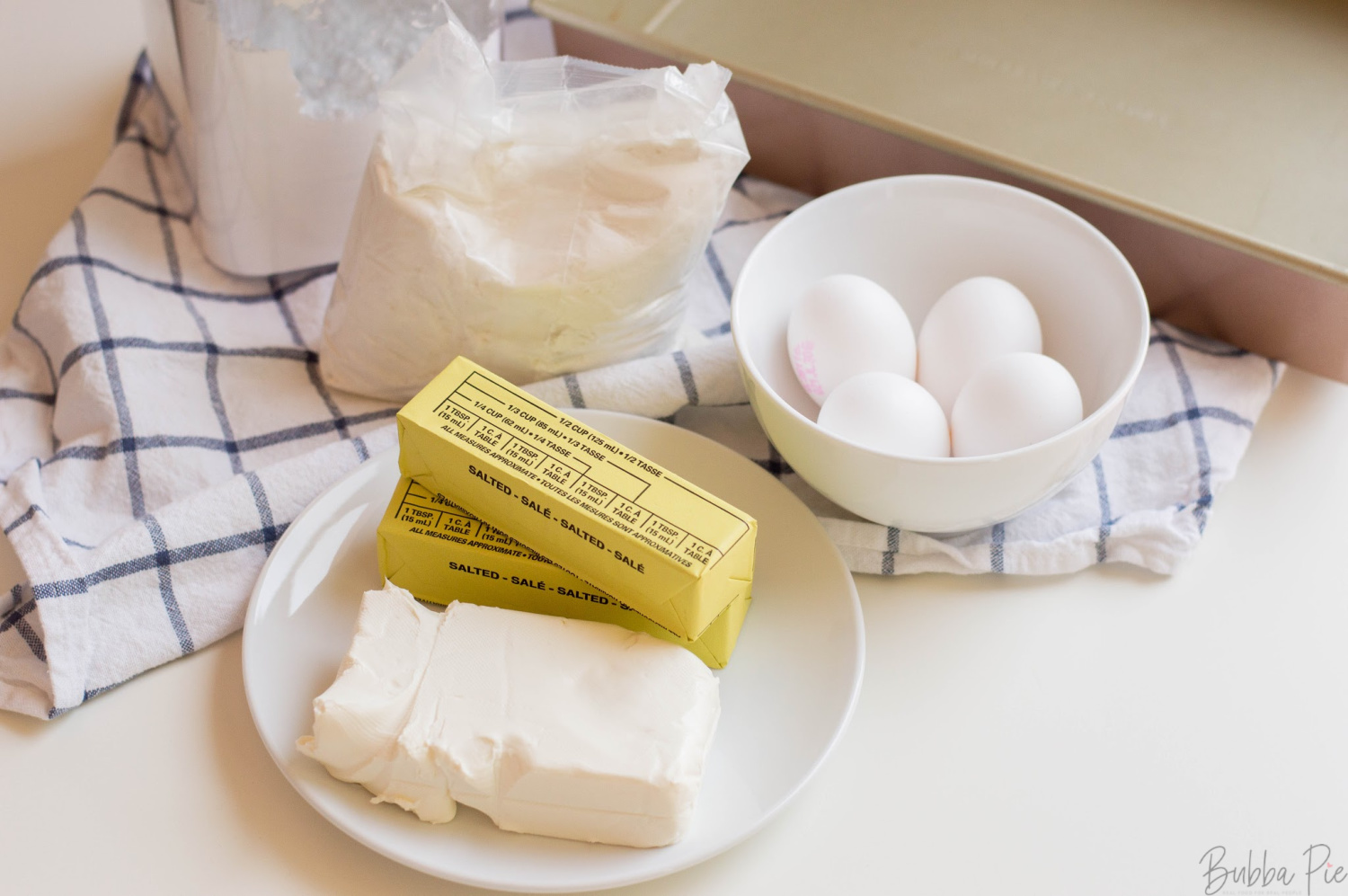 Ooey Gooey Butter Cake Ingredients include butter, vanilla, cream cheese and yellow cake mix. 