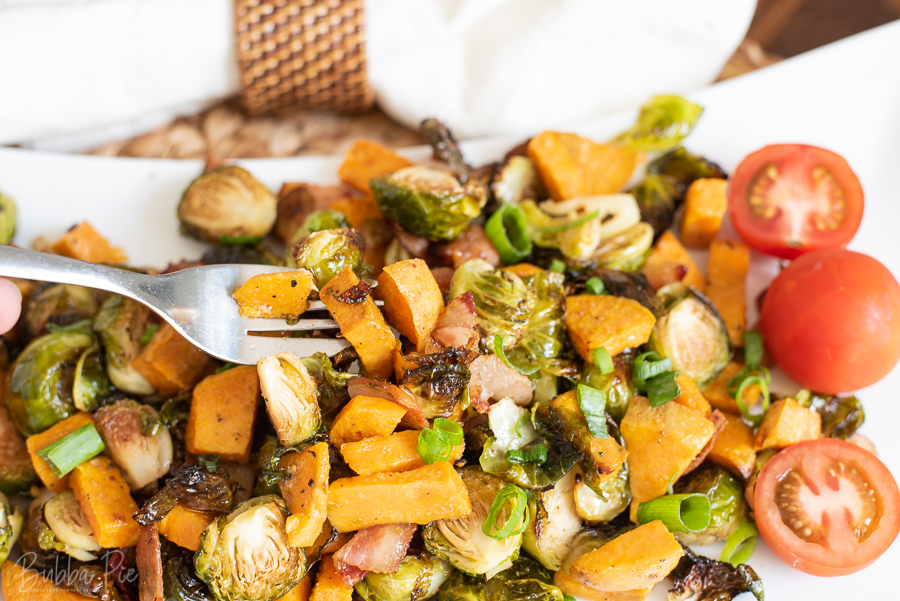 Roasted Brussels Sprouts with Sweet Potatoes being served for dinner.