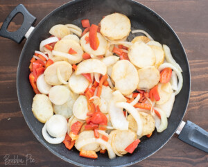 Smothered Potatoes With Sausage in skillet.