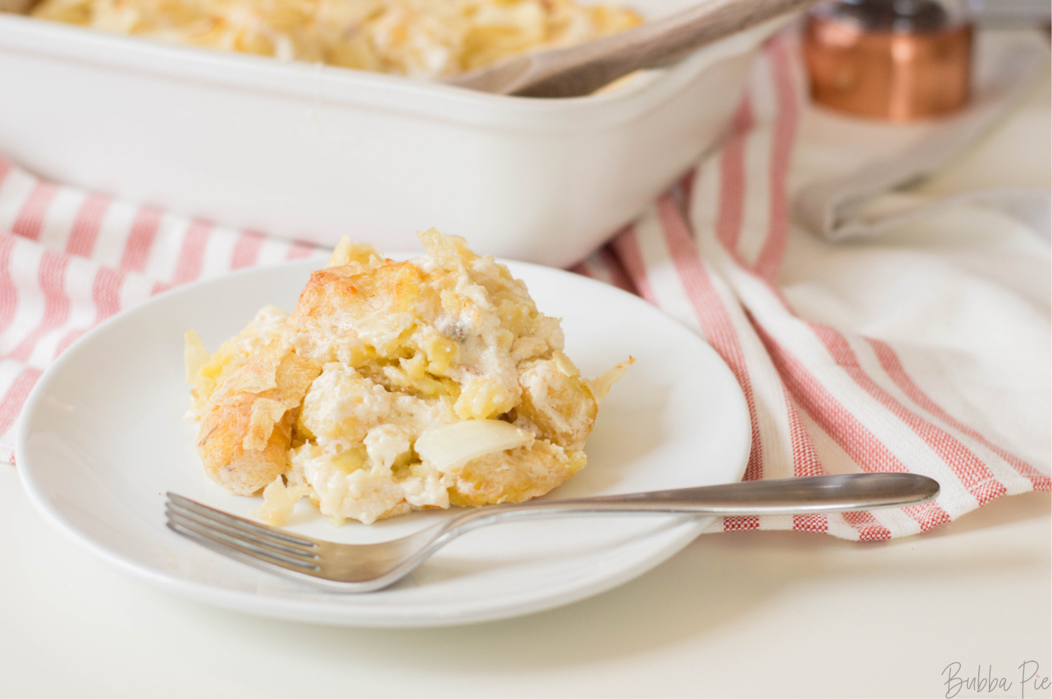 Cheesy Funeral Potatoes being served for a crowd.